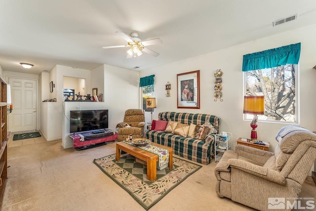 living room with ceiling fan and carpet floors