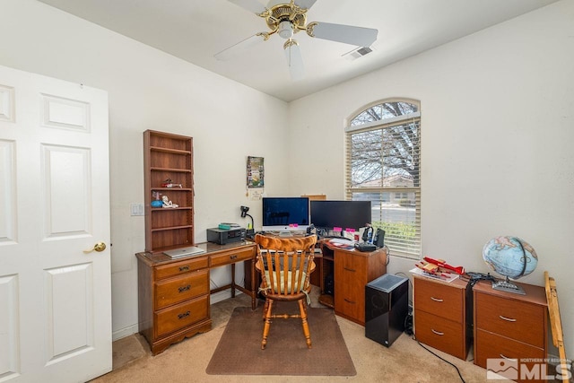 carpeted office space featuring ceiling fan