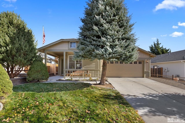 view of front of house with a garage, covered porch, and a front lawn