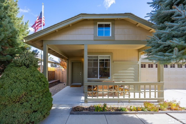 view of front of property featuring a porch and a garage