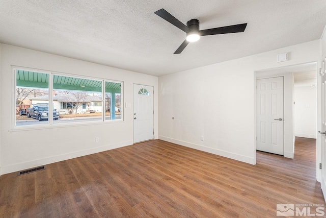 foyer with wood-type flooring, a textured ceiling, and ceiling fan