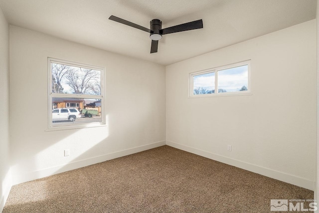 unfurnished room featuring ceiling fan and carpet floors