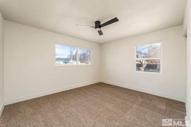 spare room with carpet flooring, a textured ceiling, and ceiling fan