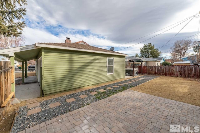 view of property exterior with a patio area