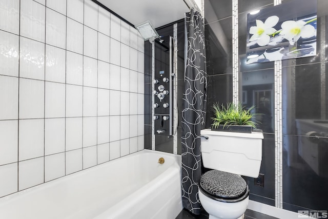 bathroom with shower / bath combo, toilet, and tile walls