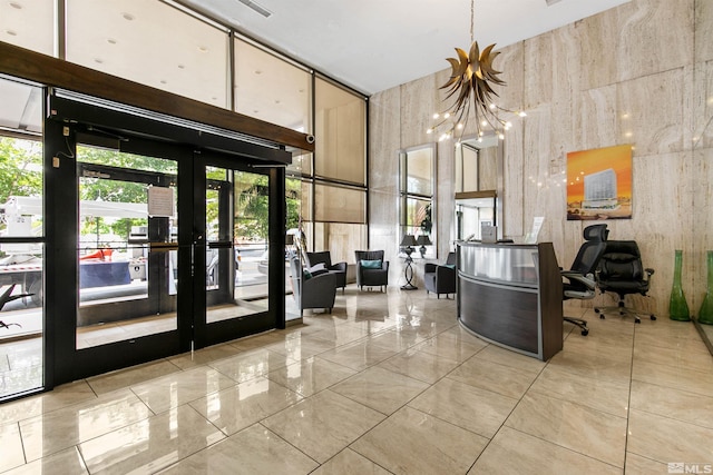 welcome area with a chandelier and french doors