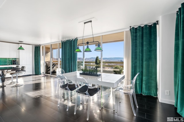 dining space with a mountain view and floor to ceiling windows