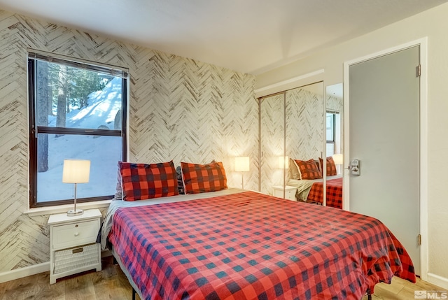 bedroom with a closet and light hardwood / wood-style flooring