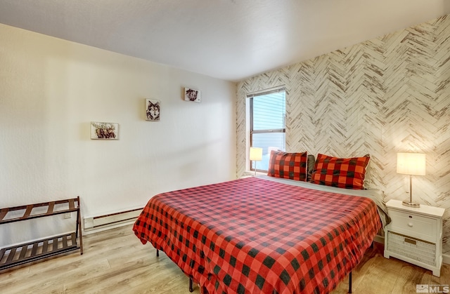 bedroom featuring baseboard heating and light wood-type flooring