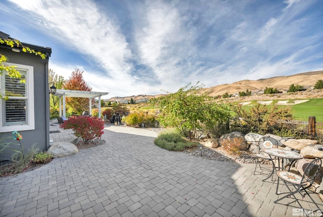 view of patio with a pergola and a mountain view