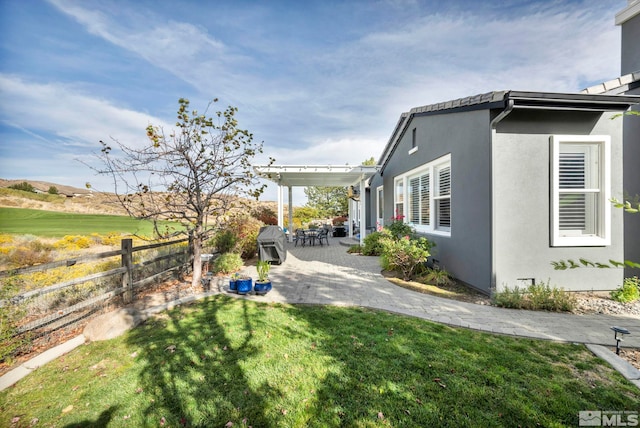 view of yard with a pergola and a patio area