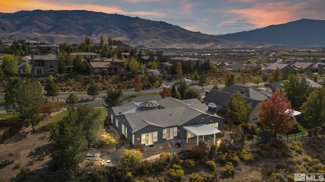 aerial view at dusk featuring a mountain view