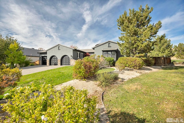 view of front of property featuring a front lawn and a garage