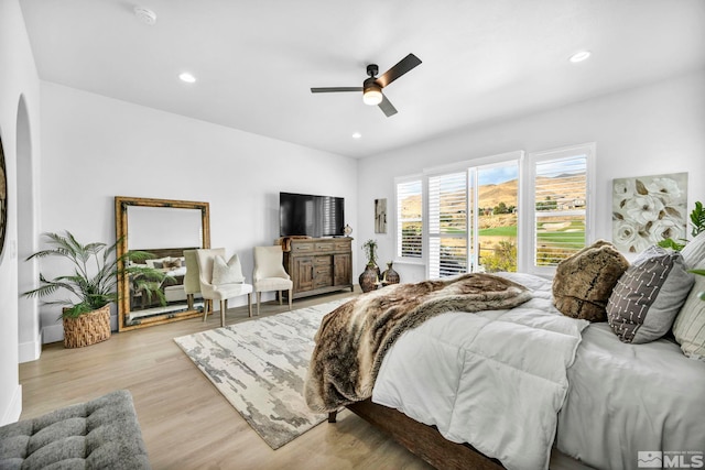 bedroom with light wood-type flooring and ceiling fan