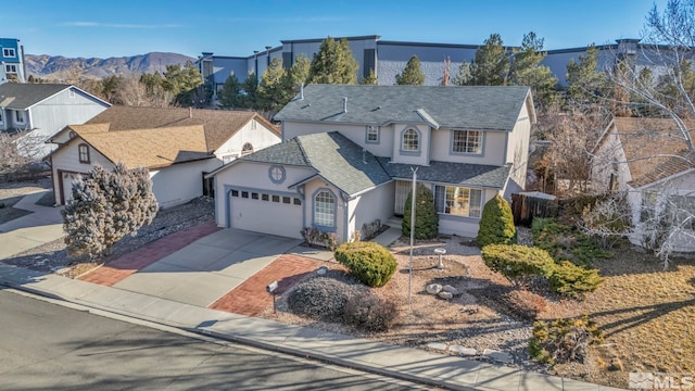 front of property with a mountain view and a garage