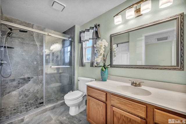 bathroom featuring vanity, toilet, and a shower with door