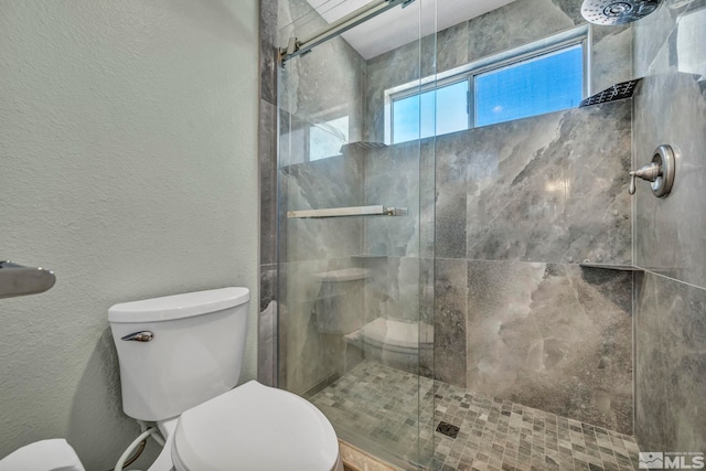 bathroom with an enclosed shower and toilet