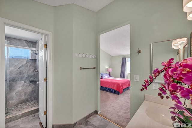 bathroom featuring vanity, a shower with door, and a textured ceiling