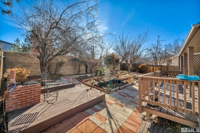 wooden terrace featuring a patio