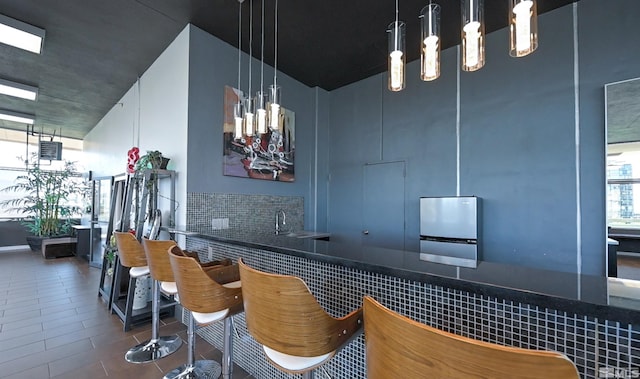 bar featuring sink and decorative light fixtures