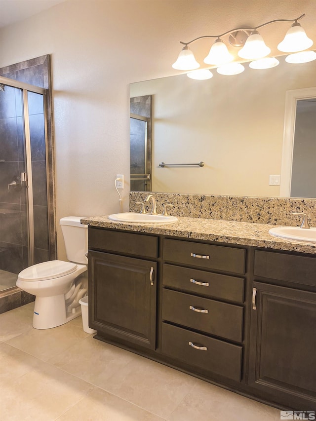 bathroom with toilet, tile patterned flooring, an enclosed shower, and vanity