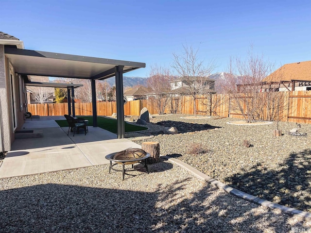 view of yard with a fire pit and a patio