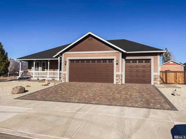 ranch-style house with covered porch and a garage