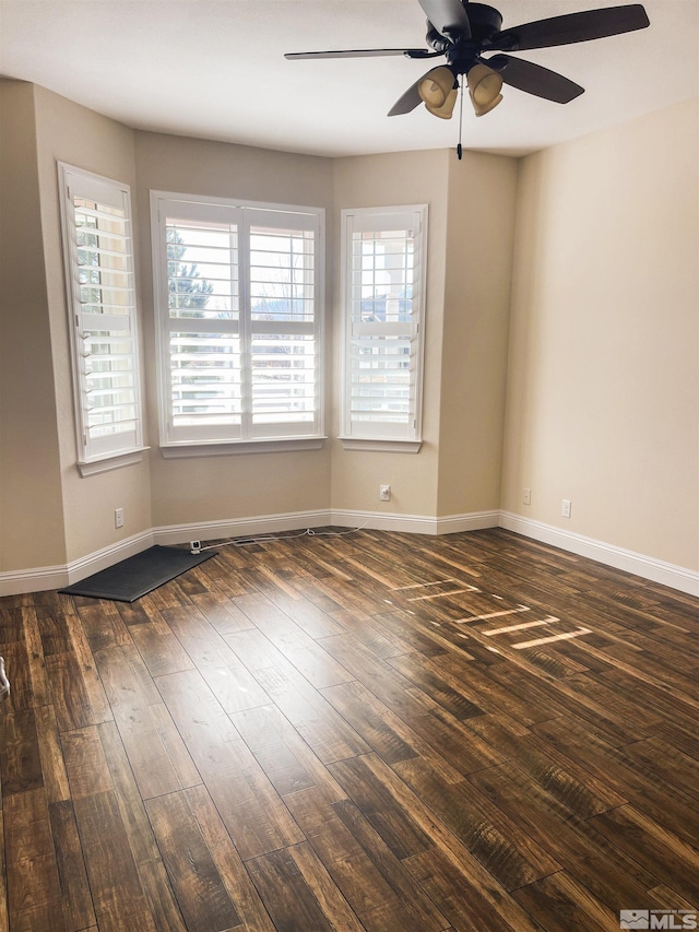 unfurnished room featuring ceiling fan and dark hardwood / wood-style floors