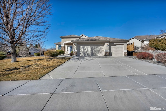 view of front of house featuring a front lawn and a garage