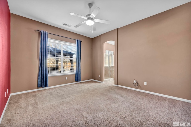 spare room with ceiling fan and carpet