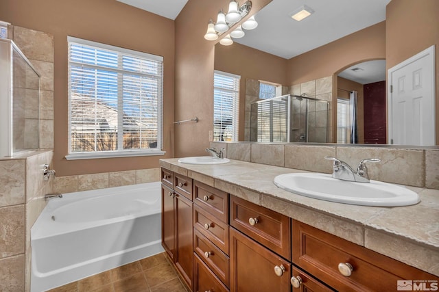 bathroom with plus walk in shower, tile patterned floors, and vanity