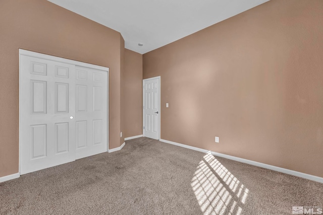 unfurnished bedroom with a closet and carpet flooring