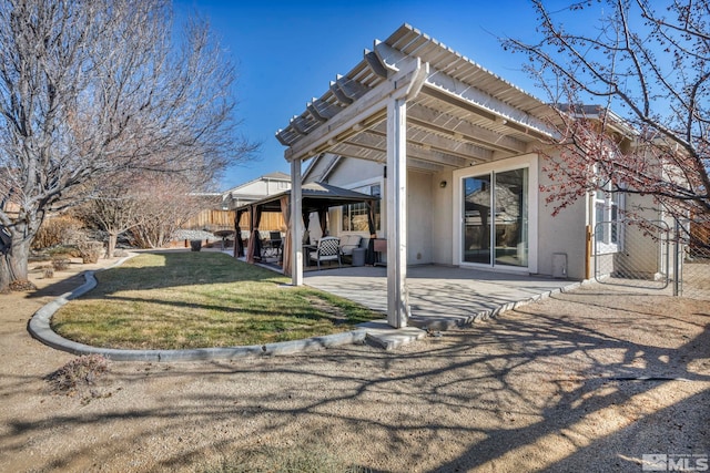 back of house featuring a patio area, a yard, and a pergola