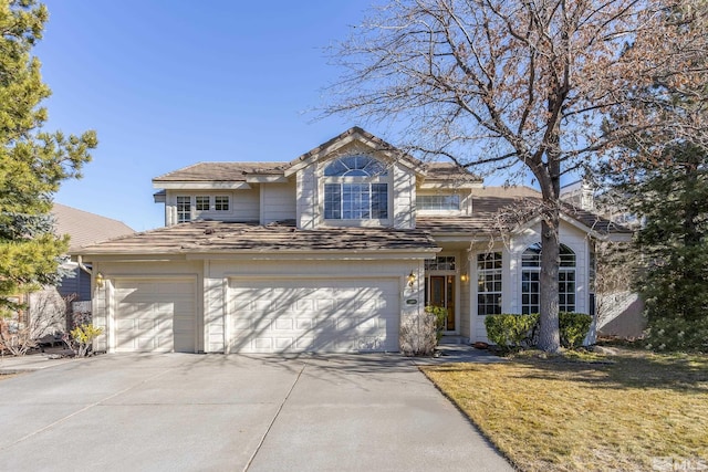 front facade with a front yard and a garage