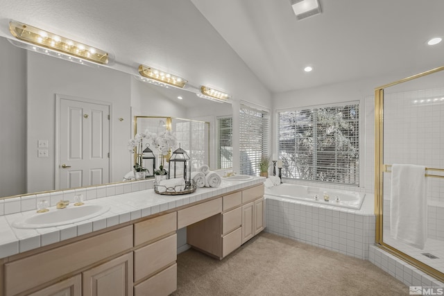 bathroom with vaulted ceiling, vanity, and independent shower and bath