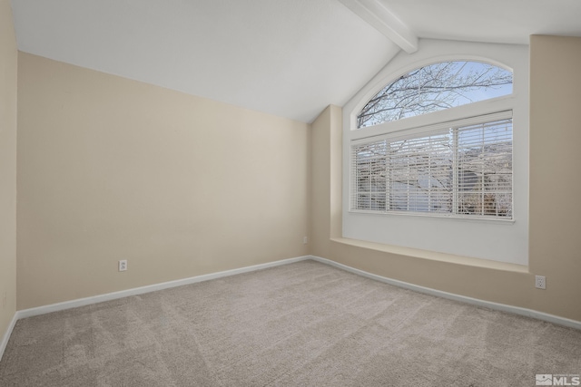 carpeted spare room featuring vaulted ceiling with beams