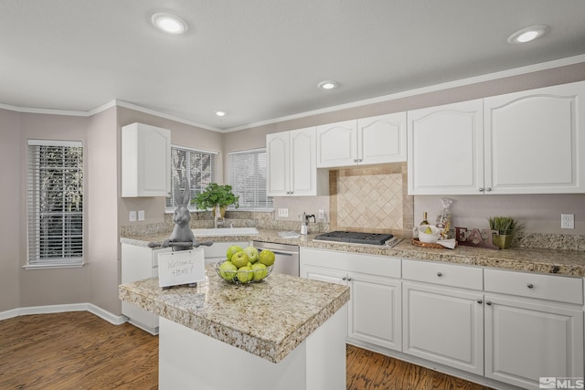 kitchen with stainless steel appliances, a kitchen island, white cabinetry, and dark wood-type flooring