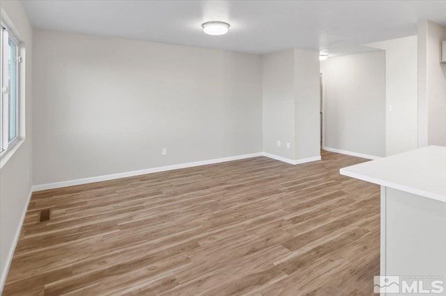 unfurnished room featuring hardwood / wood-style flooring