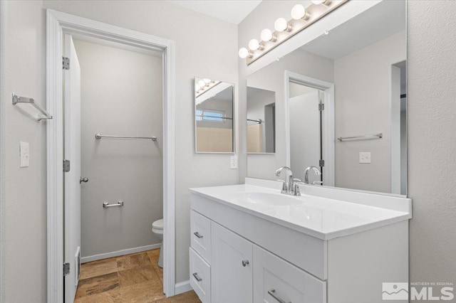 bathroom with toilet and vanity