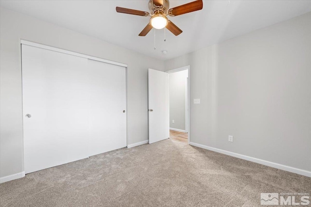 unfurnished bedroom featuring carpet flooring, a closet, and ceiling fan