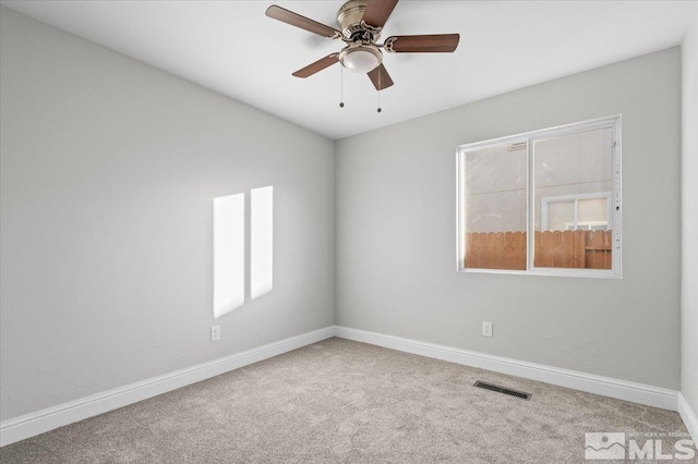 carpeted spare room with ceiling fan