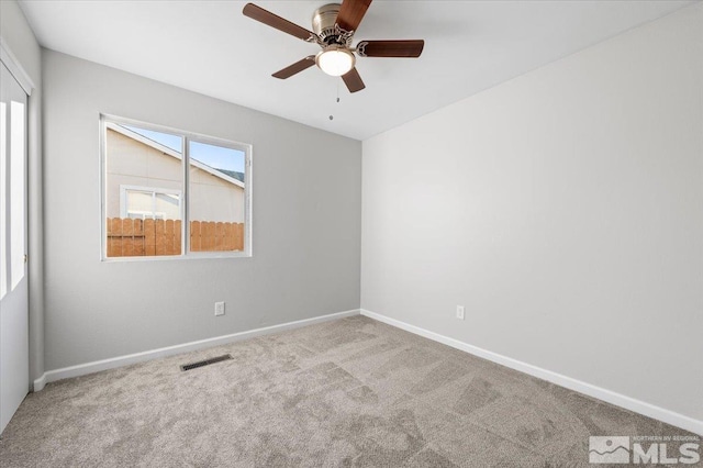 empty room with ceiling fan and light colored carpet