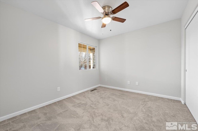 unfurnished room with ceiling fan and light carpet