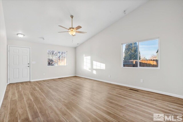 unfurnished room featuring ceiling fan, light wood-type flooring, and high vaulted ceiling