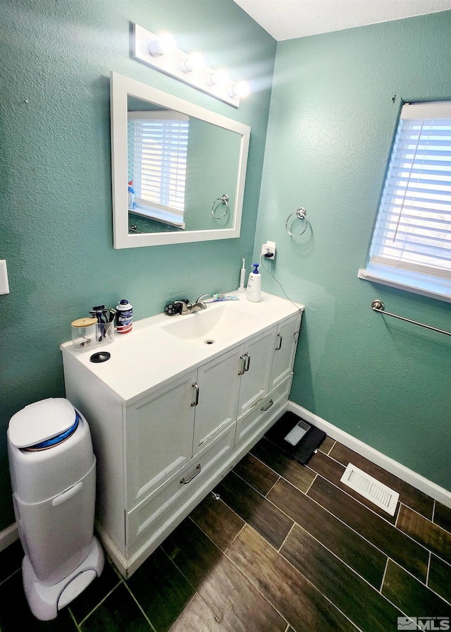 bathroom featuring a healthy amount of sunlight and vanity