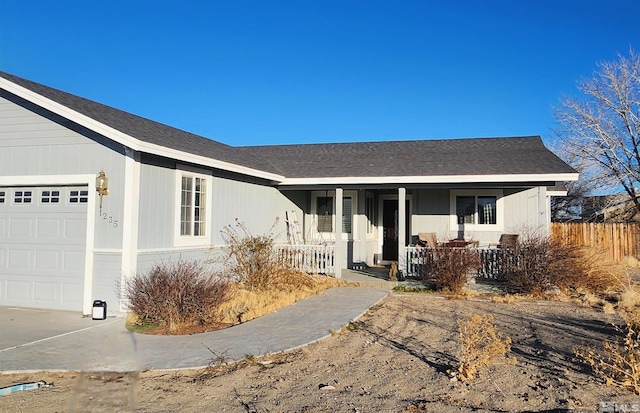 ranch-style house featuring a garage and covered porch