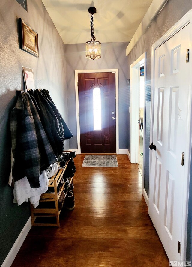 foyer with a chandelier and hardwood / wood-style floors