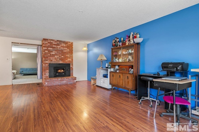 office space with a textured ceiling and wood-type flooring