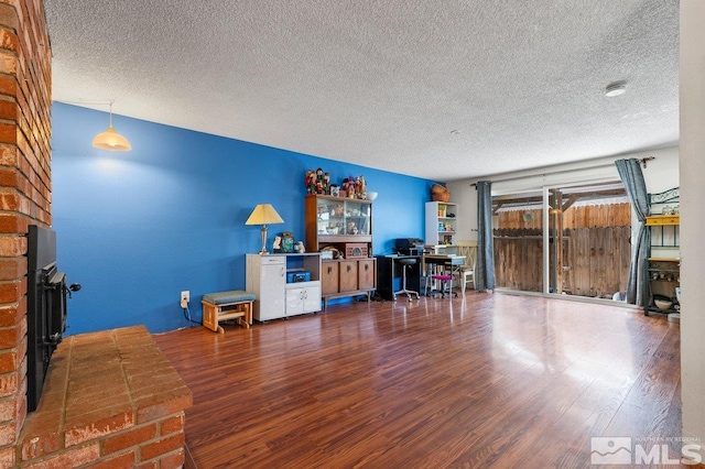 unfurnished living room with a textured ceiling and hardwood / wood-style floors