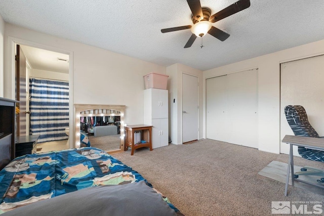 bedroom featuring a textured ceiling, two closets, ceiling fan, and carpet